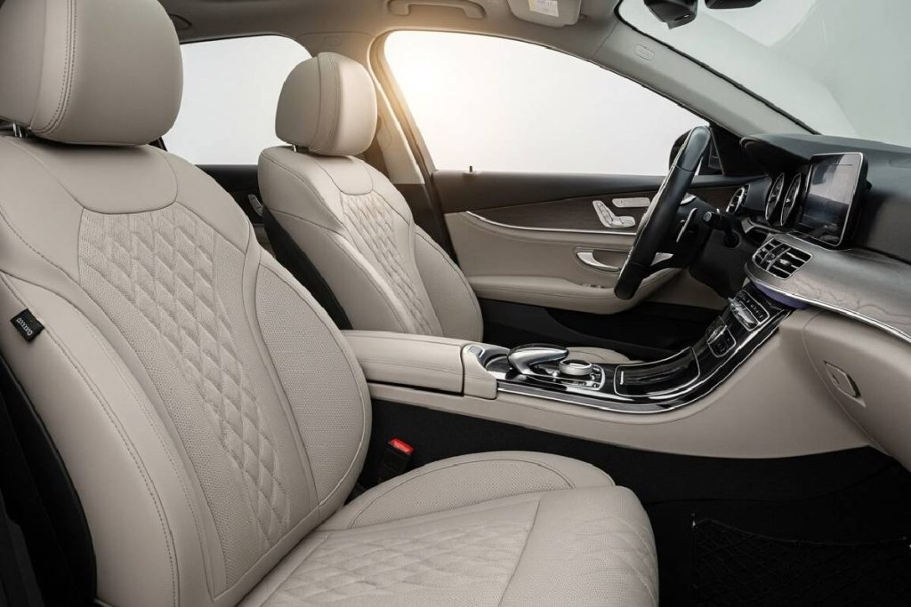 Leather seat covers protecting car interior from dust and heat in Pakistan.