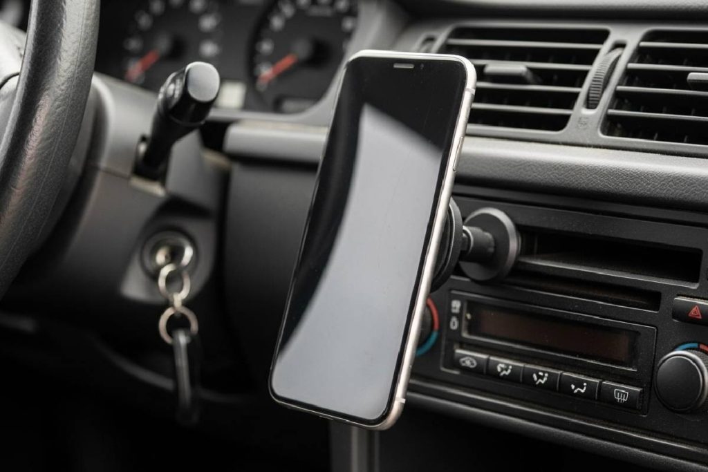 Smartphone mounted in a car using a CD slot magnetic phone holder.